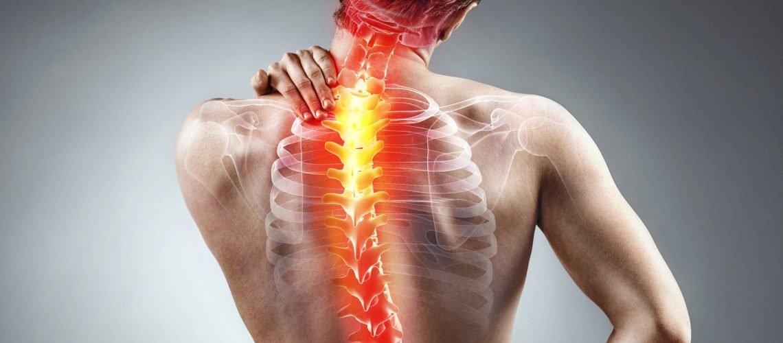 Young man holding his neck in pain. Medical concept.